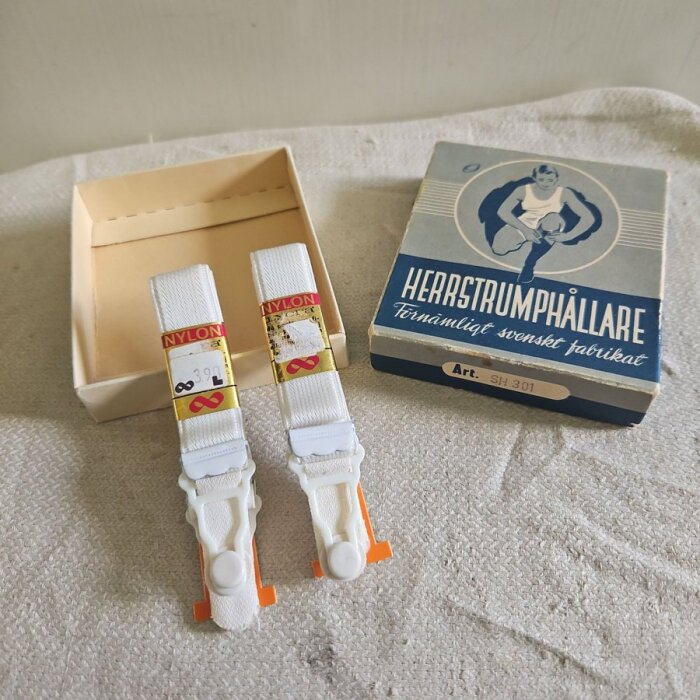 Herrstrumphållare i vitt med originalkartong från en svensk fabrik, märkt "nylon". Design från 60-talet.
