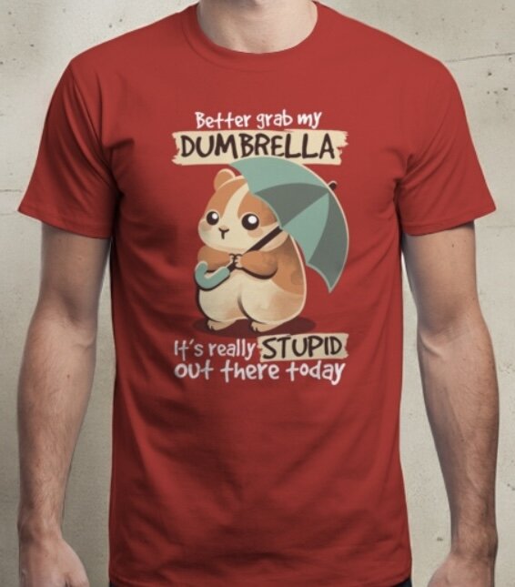 T-shirt med en söt illustration av ett djur med ett paraply, texten "Better grab my dumbrella, it's really stupid out there today" på framsidan.