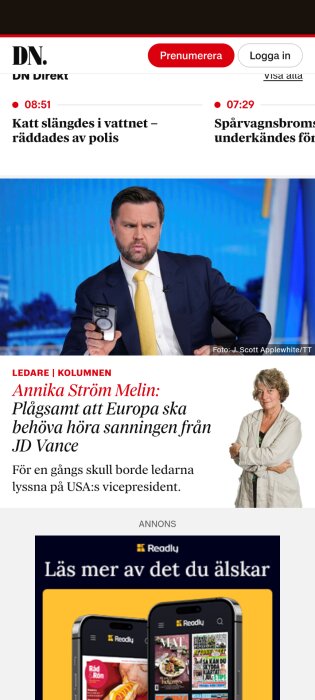 Person i kostym håller telefon i tv-studio; tidningsrubrik om Europas ledare och JD Vance visas.