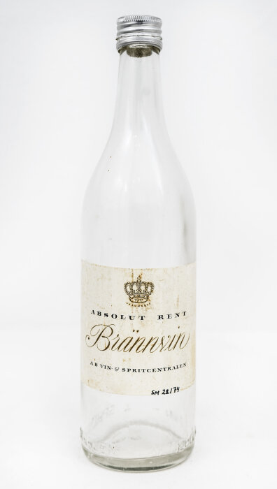 En flaska märkt "Absolut Rent Brännvin" från AB Vin & Spritcentralen med etikett och skruvkork, historisk dryck från 1800- och 1900-talet.