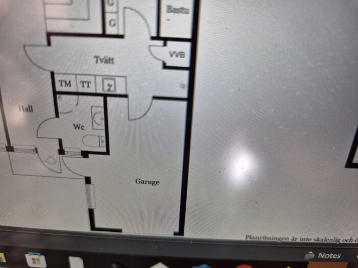 Planritning av hus med markerade områden för tvättstuga, WC, hall och garage; notering om ombytta placeringar för TM och TT.