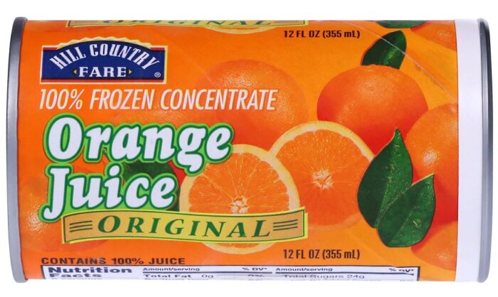 Förpackning med fryst koncentrerad apelsinjuice, märkt "Orange Juice Original", dekorerad med apelsiner och blad, 355 ml.