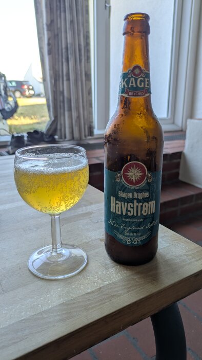 Flaska och glas med Skagen Bryghus Havstrøm öl på ett bord, inomhusmiljö.