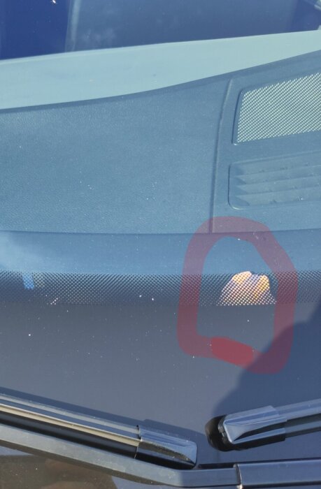 Bilruta med misstänkt oxidering eller skada, markerad med röd cirkel, potentiellt luft/fuktintrång orsakat av spricka eller stenskott.