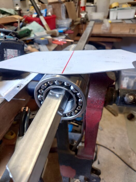 Jättestort lager på 80 mm fäst på en metallstång i en verkstad, förberedelse för installation av instrumentpanel.