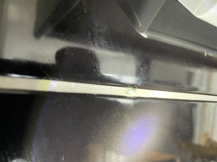 Närbild på vit beläggning under en köksfläkt i en ny byggnad, diskuterad som möjliga saltutfällningar.