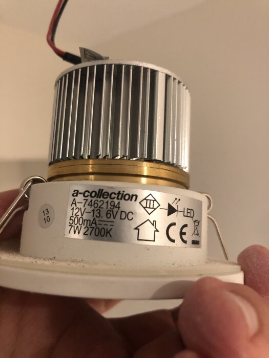 LED-spotlight med märkningen a-collection A-7462194 12V 500mA 7W 2700K, hålls i handen. Fråga om byte och kompatibilitet.