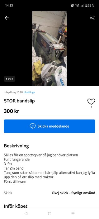 Stor bandslip i en verkstad omgiven av verktyg och påsar.