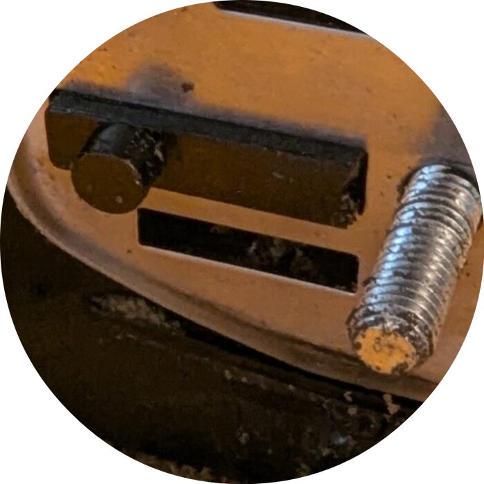 Spännare och gängad skruv på en mekanisk del, spännaren bör synas om den inte är dold i kåpan.