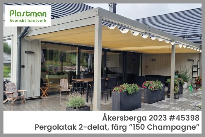 Pergola i trädgård med tvådelat tak i champagnefärg, omgiven av sittplatser och blommor i krukor, utanför ett modernt hus.