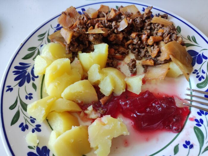 Tallrik med kålmaja, kantareller, potatis och hemgjord lingonsylt.