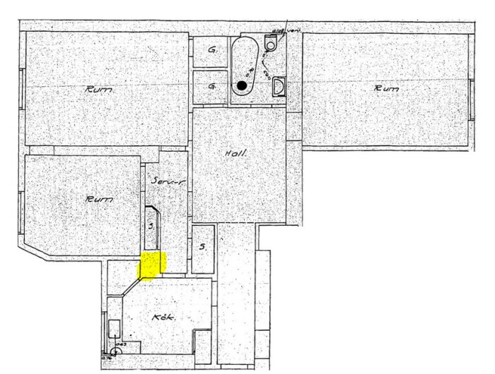 Planritning över lägenhet med markerade områden för badrum, kök och en ljusgul markering vid ventilation eller murstock i samband med ombyggnation.