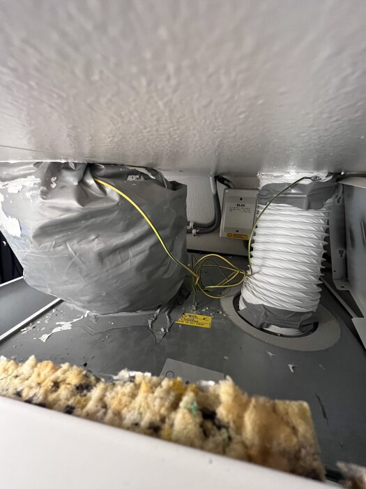 Isolerad avluftningskanal med plastöverdrag och gula kablar, diskussion om rätt isolering för byte till Nibe S375-4 frånluftsvärmepump.