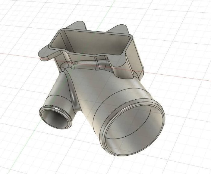 3D-modell av ett gjutet metallrör med tre anslutningar på ett rutnät.