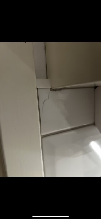 Spricka i kökskakel nära en dörrlist.