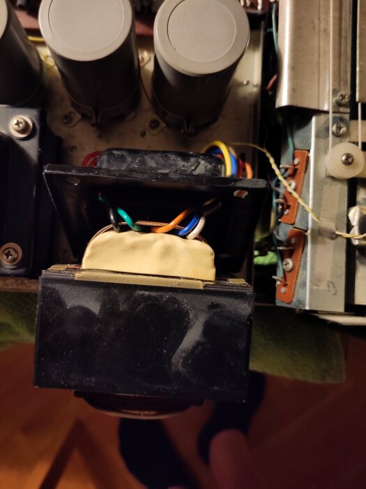 Transformator med exponerade färgade kablar och isolering.
