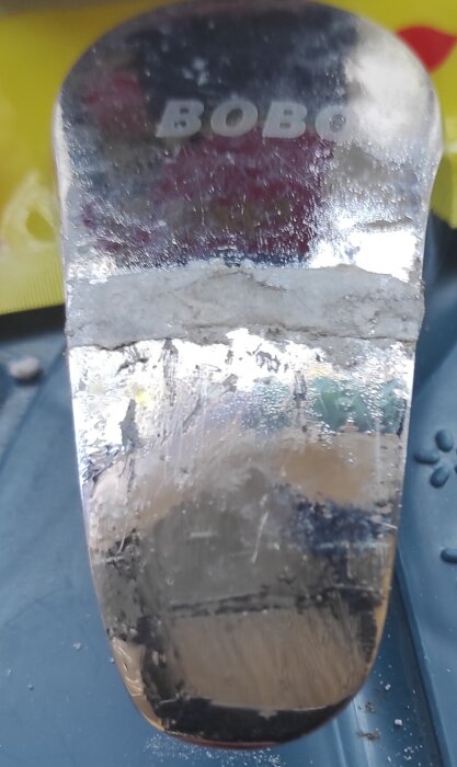 Trasigt och lagat vred till tvättställsblandare, reparerat med superlim och bikarbonat, märkt "BOBO", med flagnande kromfinish.