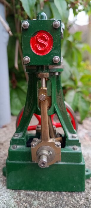Detaljerad närbild av en modell av en ångmaskin, avsedd för att drivas med tryckluft.