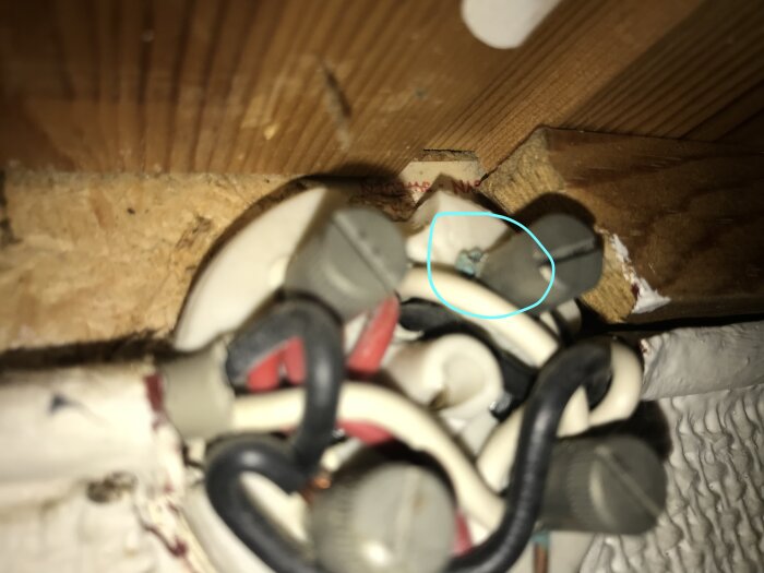 Ärgad elkabelsammansättning i en kopplingsdosa i en hall, med synligt blått ärg på en kabel.