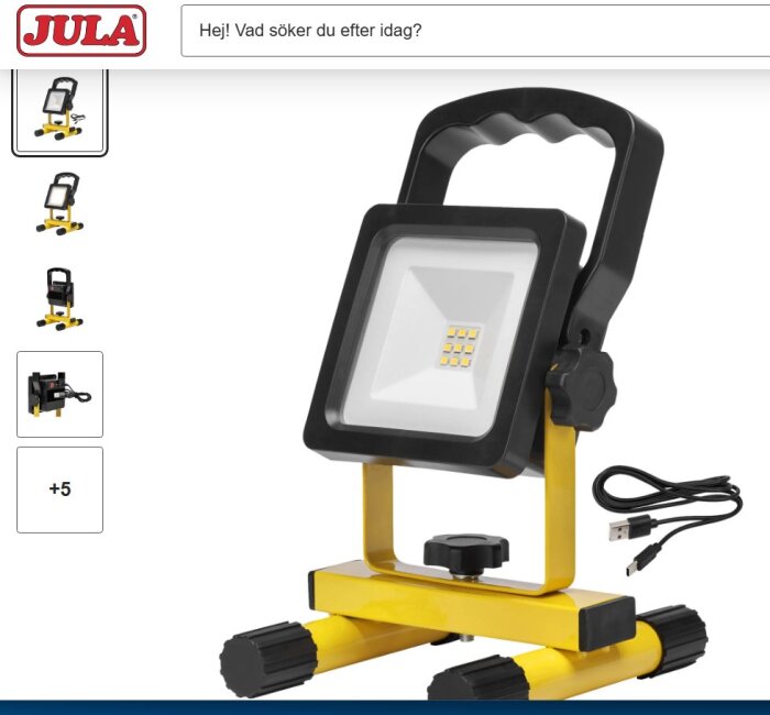 Bärbar LED-arbetslampa med handtag och USB-kabel på vit bakgrund.