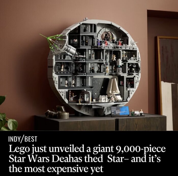 Giant LEGO Death Star model with intricate interior details and Star Wars minifigures displayed on a wooden cabinet.