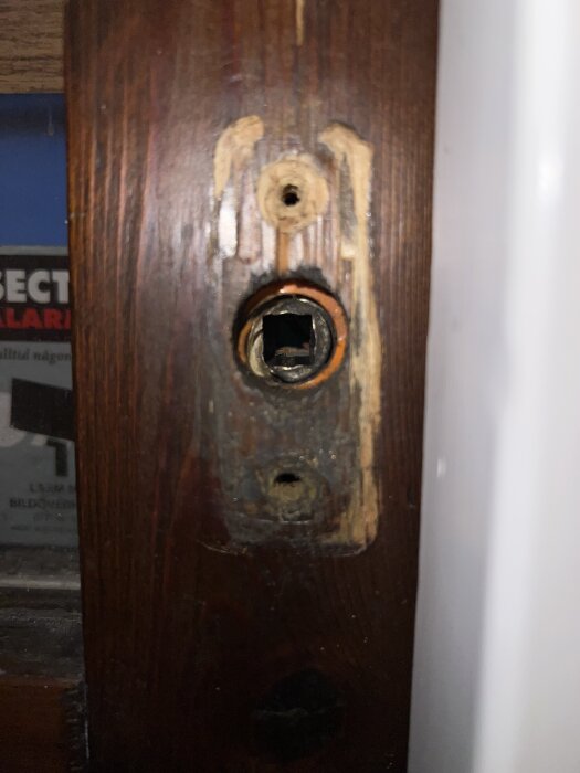 Roddarhål i träkarm på altandörr, synligt slitage runt hålet.