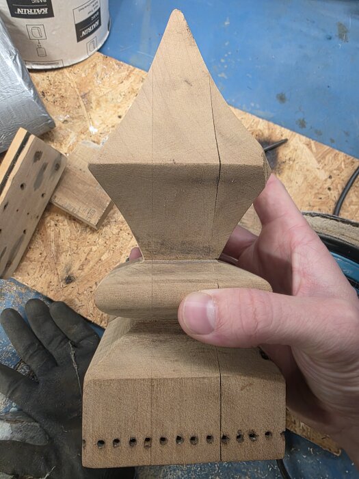 Trästycke från 1800-1900-tals fågelbur, hålls i hand. Fråga om träslag för renovering.