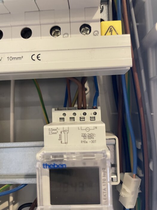 Elektrisk installation med kopplingsur och kablar anslutna till Klemmar märkta L och N i ett elskåp, med frågeställning om inkoppling.