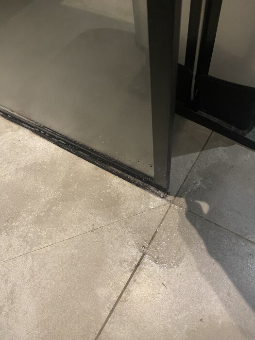 Duschvägg på gummilist, med smuts synlig på listen och tecken på rörlighet mellan väggen och listen i badrummet.