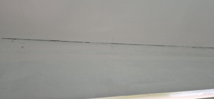 Spricka i hörnet mellan två vita väggar, diskussion om att täcka utan list och måla, möjliga metoder inkluderar sealer och spackel.