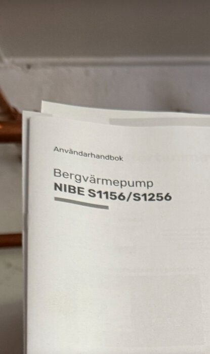 Användarhandbok för Nibe S1156/S1256 bergvärmepump, fotograferad med text synlig.