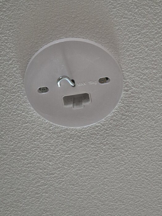 Fäste i tak för lampa med krok och märkning "MAX 15 kg".