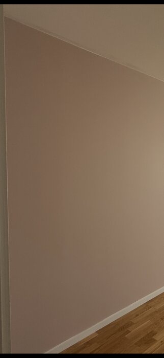 Vägg med felaktig färg på taket och misslyckat försök att täcka det med vit väggfärg.