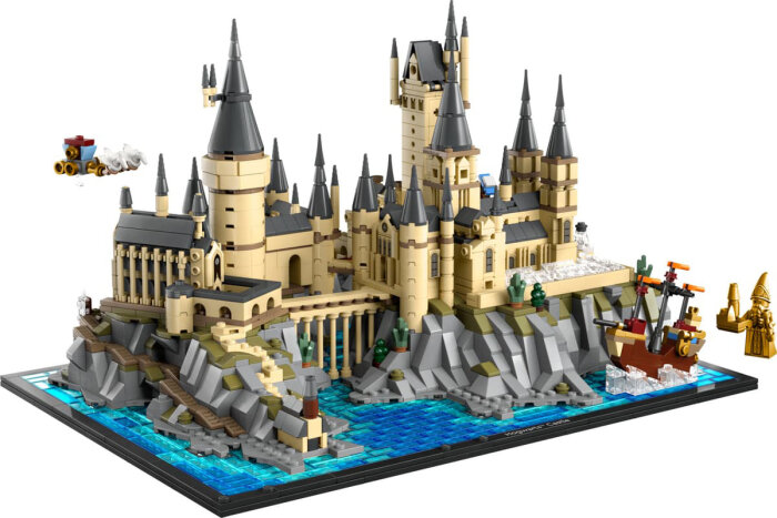 Lego Hogwarts slott- och område 76419-set med detaljerade byggnader, omgivande klippor och vatten, samt flygande angrepp pågår.