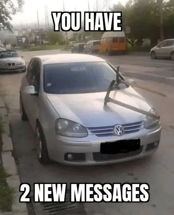 En bil med en vägbom som lyfts över huven, meme-text "You have 2 new messages" ovanför och under bilen.