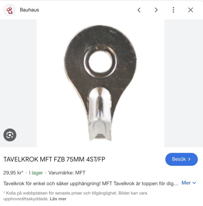 Tavelkrok i metall med rund platta och hål i mitten för upphängning.