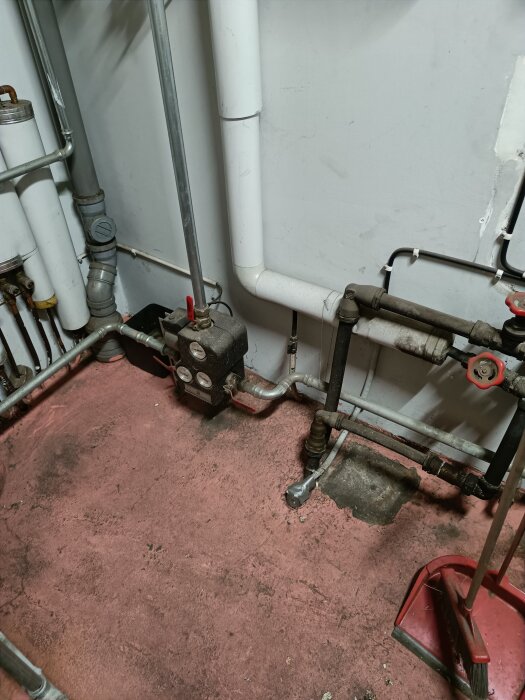 Värmesysteminstallation med rör, ventiler och en pump i ett pannrum, del av diskussion om värmeproblem i villa.