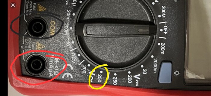 Multimeter med inställningarna för 250V~, markerade anslutningar för COM och mA spänningsprober.
