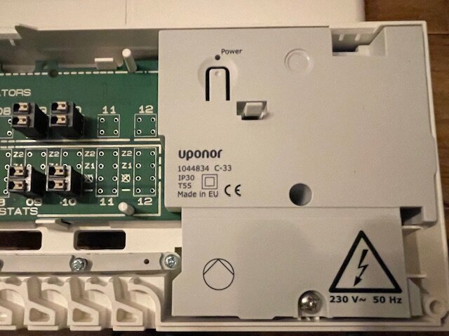 Oanvänd Uponor reglercentral, modell C-33, med märkning 230V~ 50Hz och IP30. Elektrisk symbol och anslutningspunkter synliga. Säljes för 500 kr.