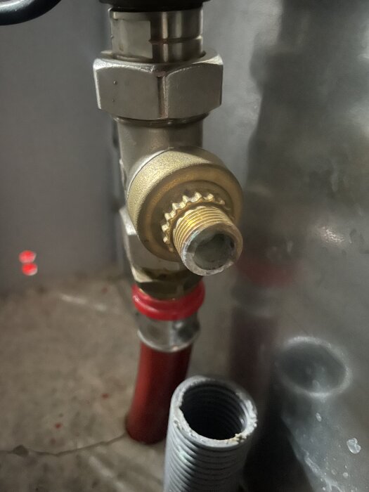 VVS-röranslutning för golvvärme med metallkoppling och rörgänga.