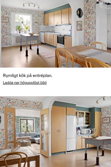 Stort kök med träinredning, färgglad tapet, stor matplats och bänk, fönster med utsikt och element under.