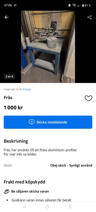 En fräs på ett metallbord i ett verkstadsrum, omgivet av rör och väggar med gul och brun yta.