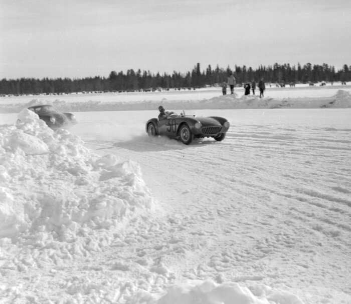Ferrari jagas av Porsche på isbana under SM i isracing 1958 eller 1959 i Vilhelmina, omgiven av snö och skog.