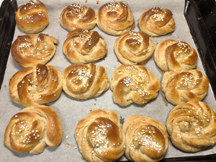 Kardemummaknutar på bakplåt, toppade med pärlsocker.