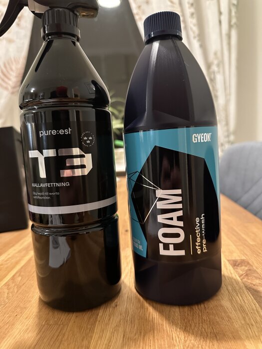 Två flaskor bilvårdsprodukter på ett bord, ena med texten "pure:est T3 kallavfettning" och den andra "Gyeon Foam effective prewash".