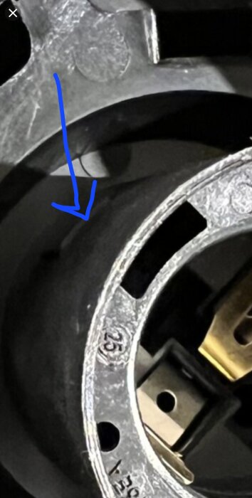 Fäste på lampsockel med blå pil som markerar plats för att öppna den.