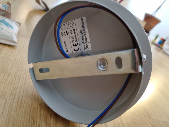 Lamputtag med blå och brun kabel, sett från undersidan med monteringsbeslag och etikett med tekniska specifikationer.