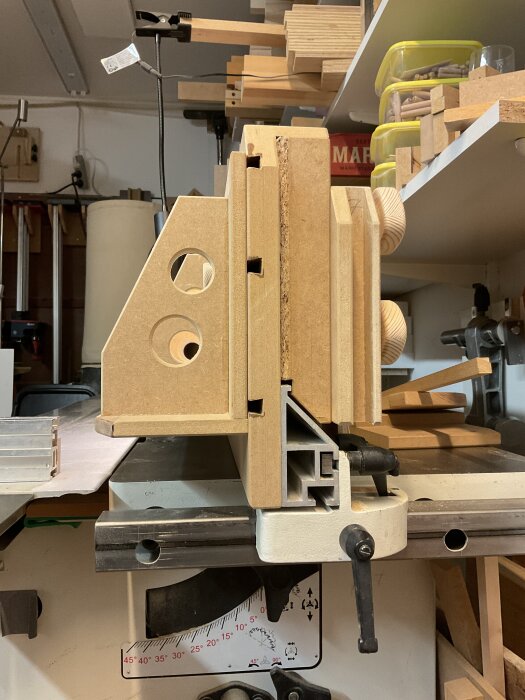 Justersåg med monterat högt anhåll och L-anhåll för att såga exakt längs en mall, synlig maskeringstejp och verktyg runtomkring.