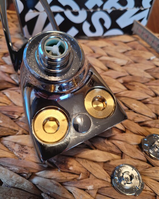 Duschblandare med invändig fattning för 10 mm insexnyckel, omgiven av verktyg och material i en verkstadsmiljö.