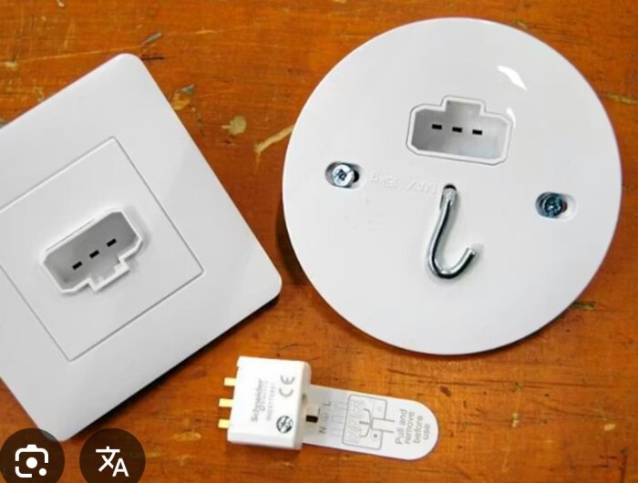 DCL-kontakter och uttag för lampinstallation ligger på ett träbord.